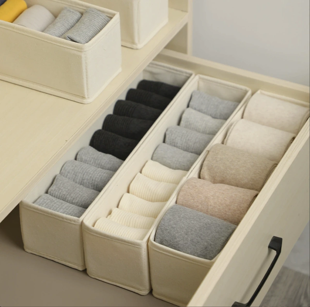 Socks arranged in fabric compartment organizers offered as a customizable packaging option
